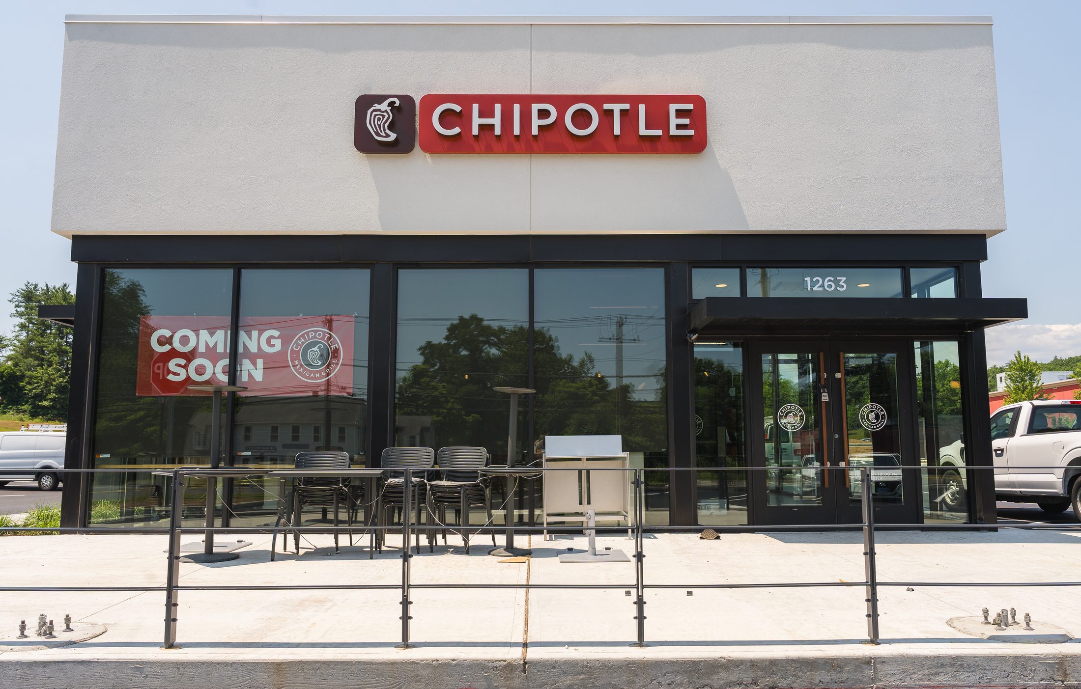 New Chipotle storefront with black entrance canopy and window awning shade by Manchester Awning