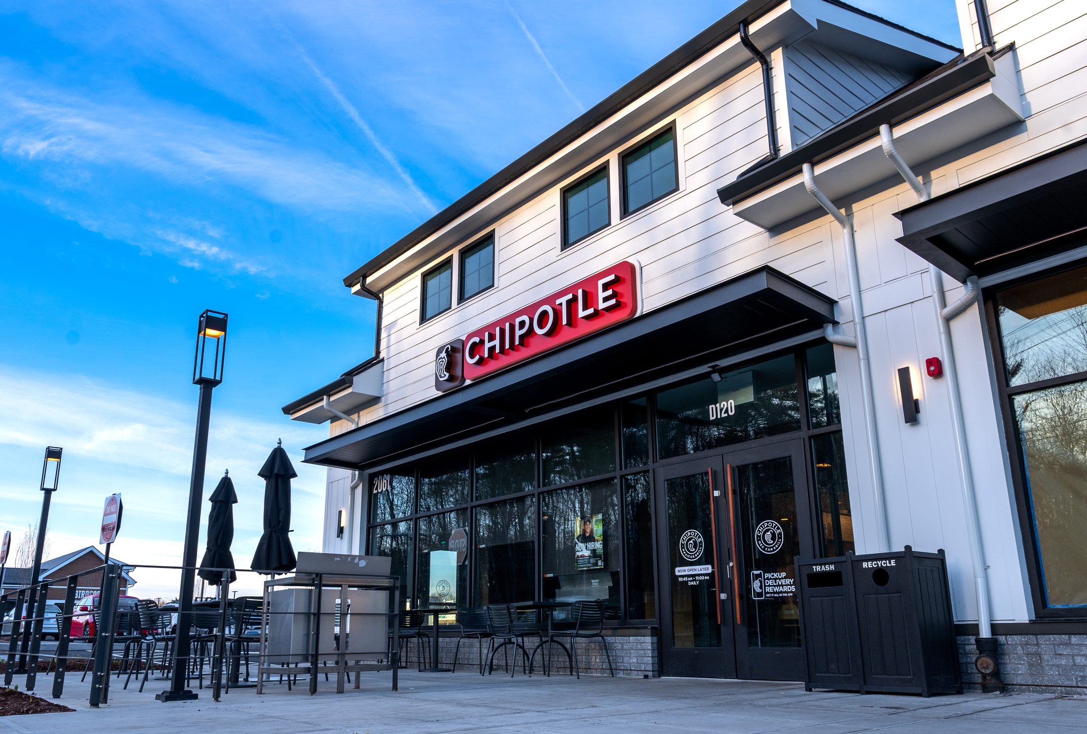 Chipotle storefront with black metal awning and patio by Manchester Awning