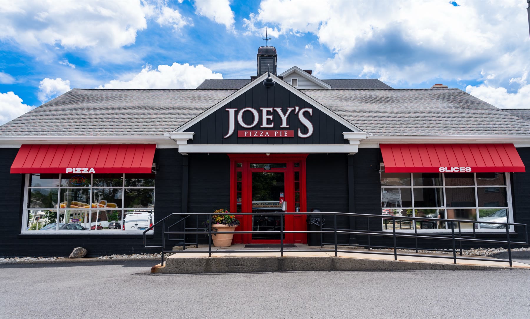 Front elevation of Joey's Pizza Pie in Connecticut with deep red standing-seam metal-look fabric awnings by Manchester Awning