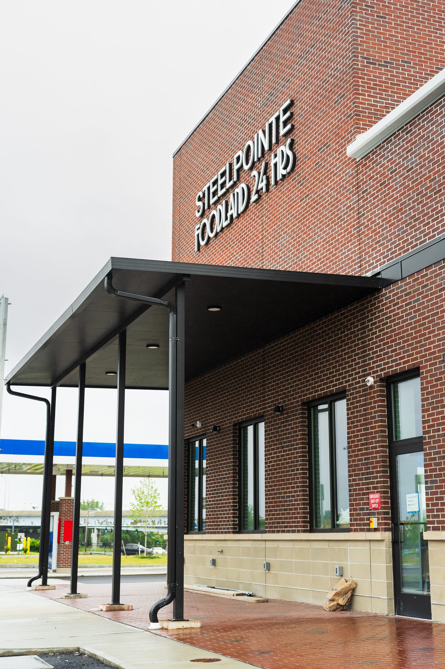 Covered customer walkway canopy on steel columns at Steelpointe Foodland by Manchester Awning