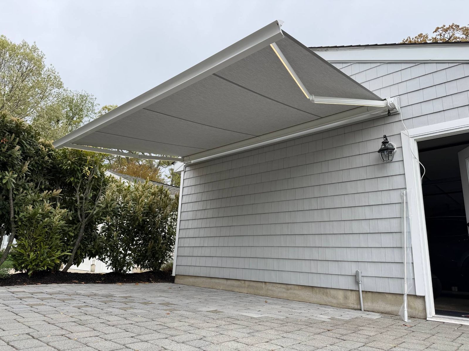 Salute awning extended at dusk with the optional integrated LED arms illuminated